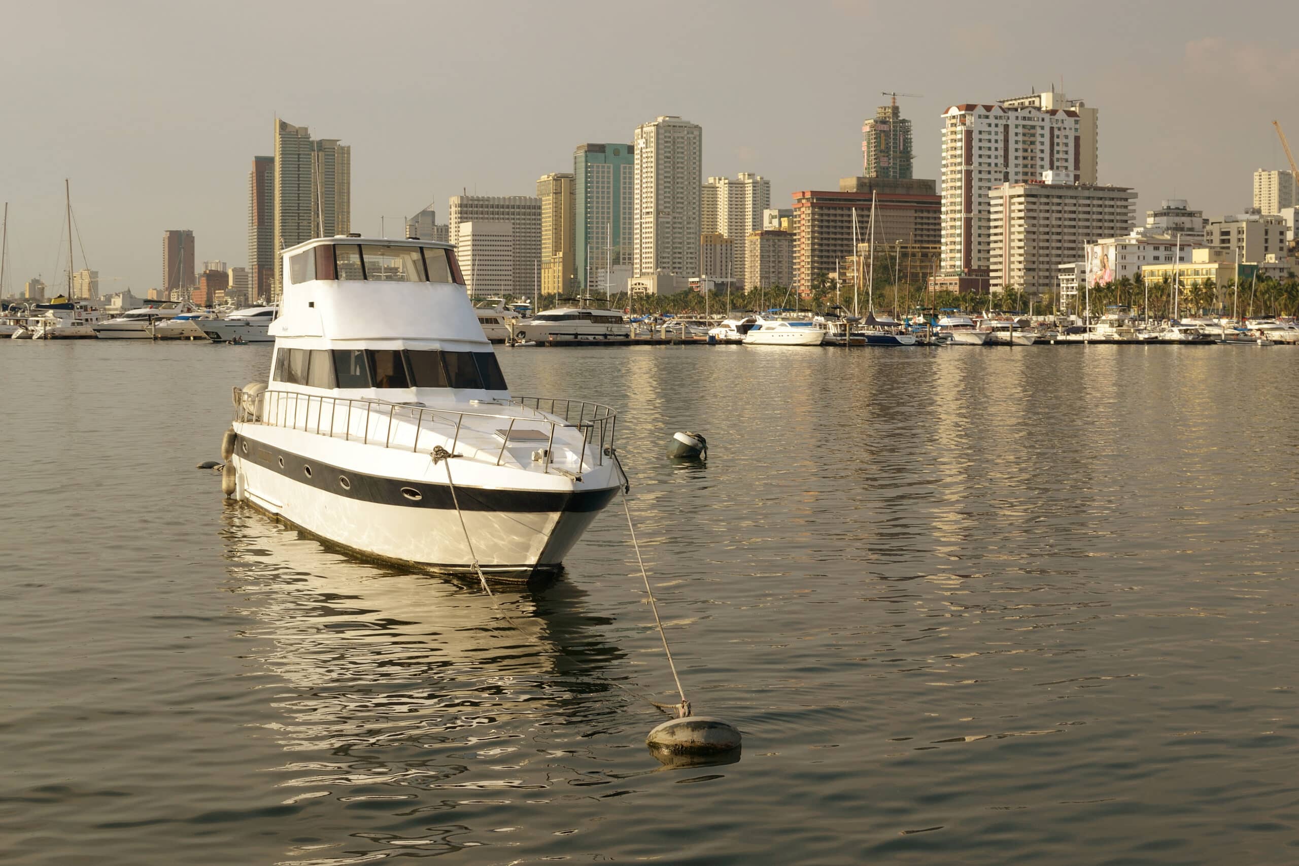 docked luxury boat electric inboard motor with city skyline in the background